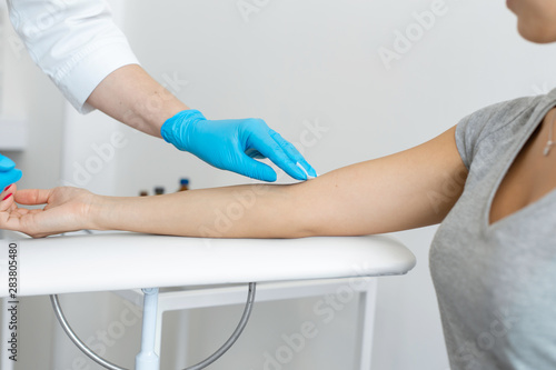 the nurse rubs the hand with alcohol before taking blood from a vein for testing. Disinfects the place of introduction of a needle with antiseptic © Kate
