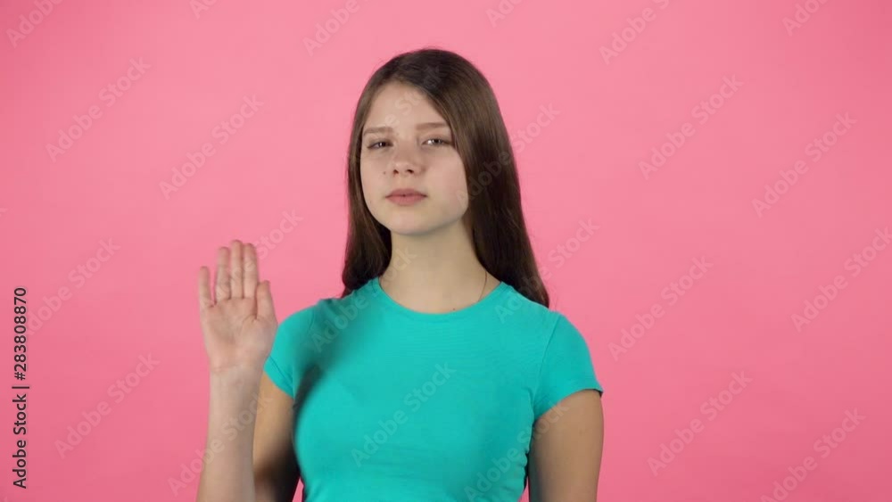 Cute girl is waving hello and inviting to come to her with hands. Slow motion Cute girl is waving hello and inviting to come to her with hands. Slow motion