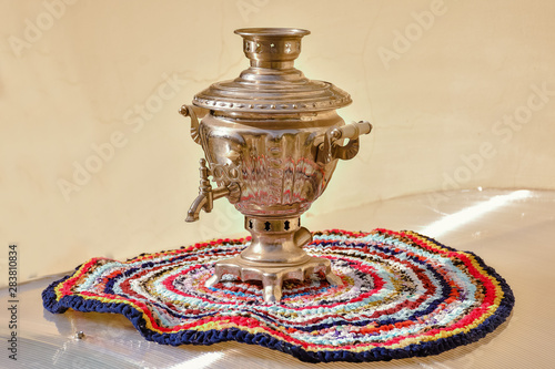 Golden samovar on knitted stand
