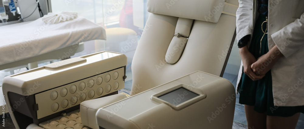 Fototapeta premium Doctors hands close-up against modern health diagnostic equipment.