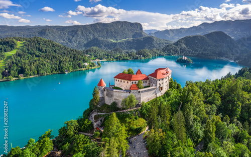 Bled, Slovenia - Aerial panoramic view of beautiful Bled Castle (Blejski Grad) with Lake Bled (Blejsko Jezero), the Church of the Assumption of Maria and Julian Alps at background on a summer day photo