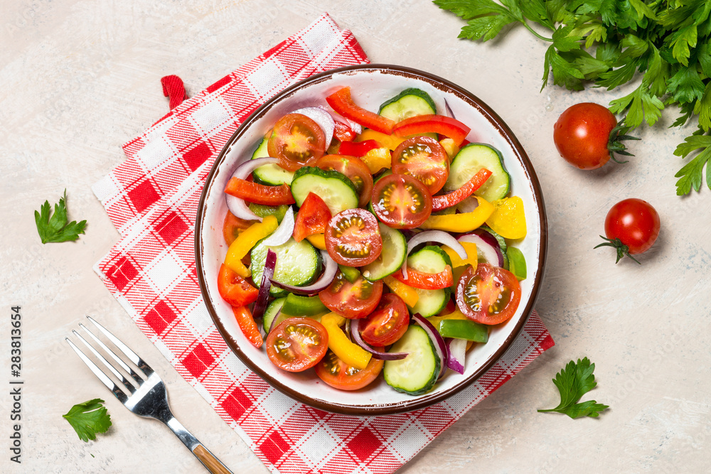 Summer fresh vegetable salad on light table top view. Summer fresh vegetable salad on light table top view.