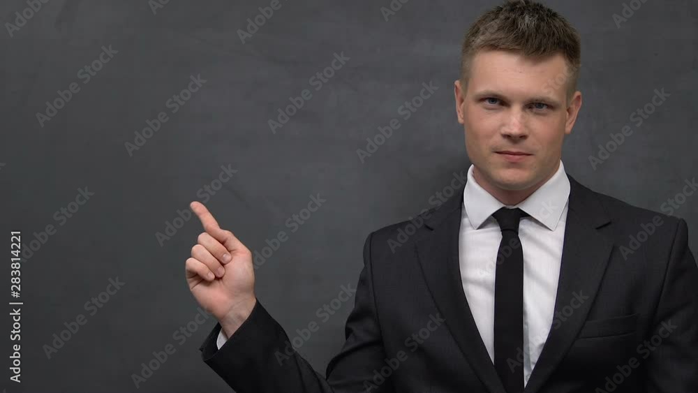 Man in business suit pointing finger at blackboard, feeling nervous, ethics tips Man in business suit pointing finger at blackboard, feeling nervous, ethics tips