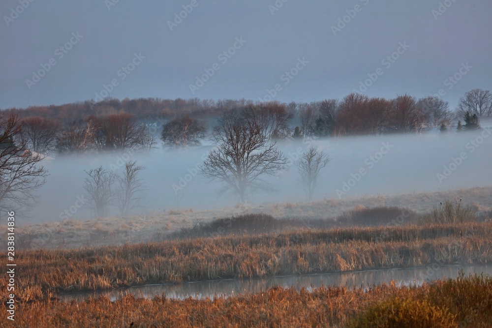 Morning fog over river and farm