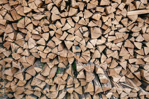 Dried wood for burning bonfire. Background of dry chopped wood folded for the fireplace. A pile of firewood for heating a house.