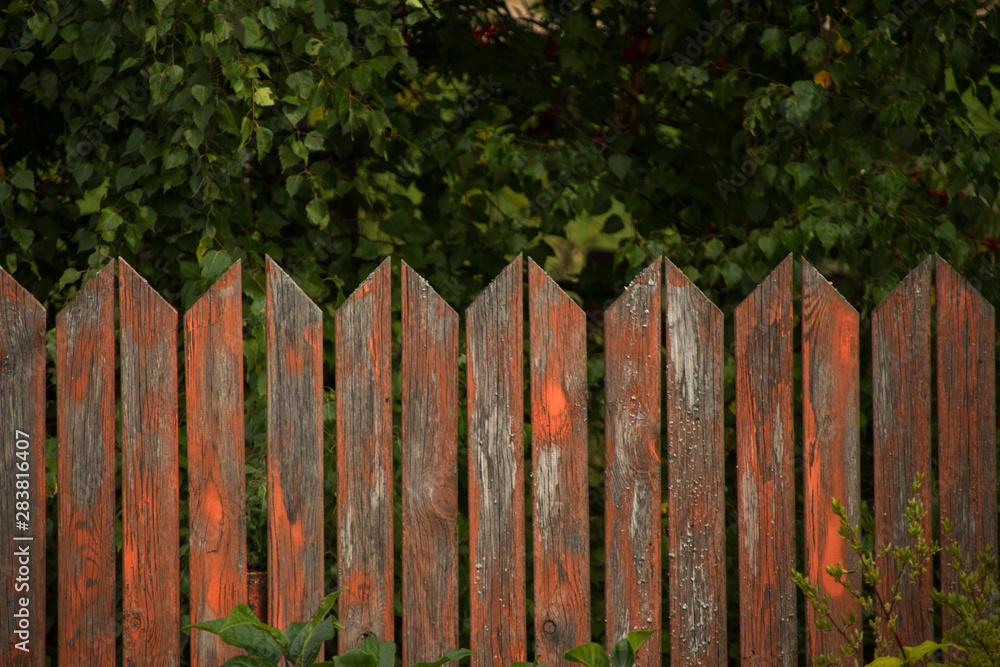curved red wooden fence with peeling paint curved red wooden fence with peeling paint
