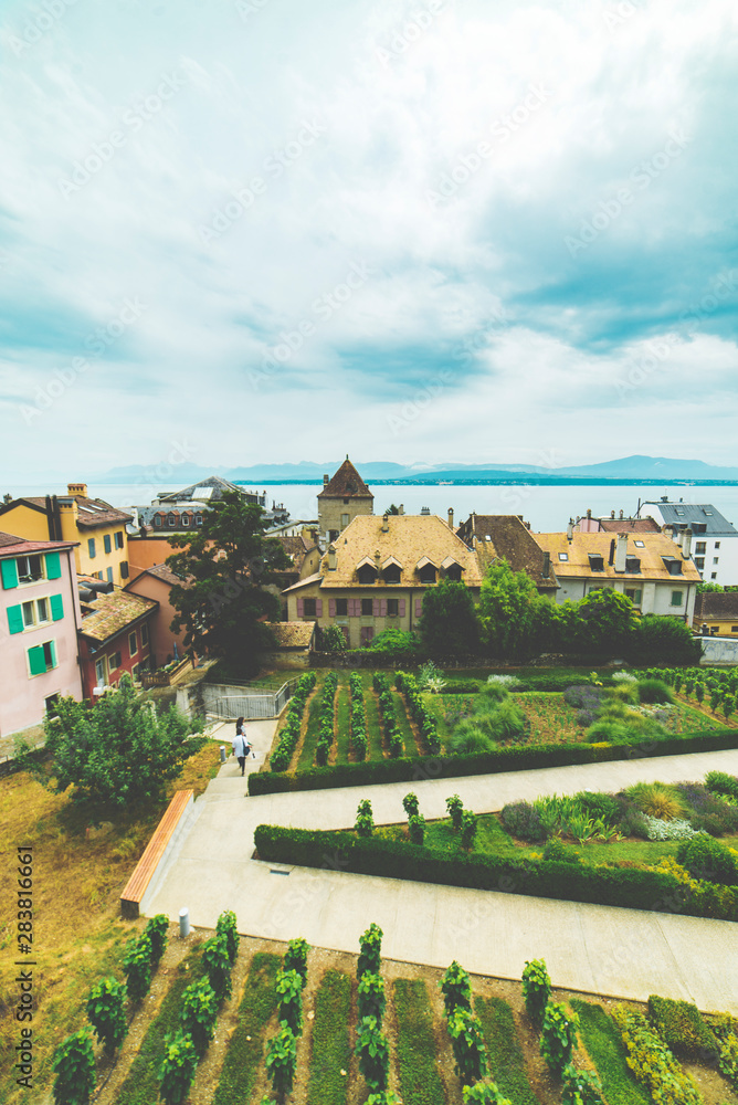 Green castle garden, town houses and lake Geneve