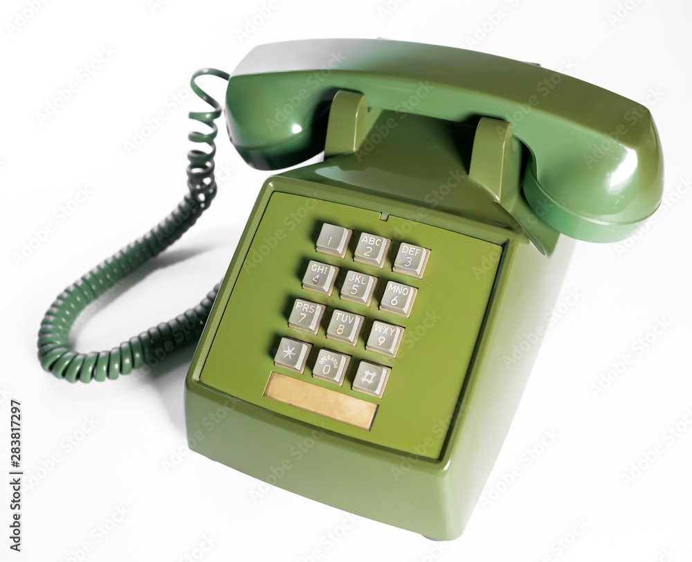 Retro push button rotary dial telephone. Vintage avocado green