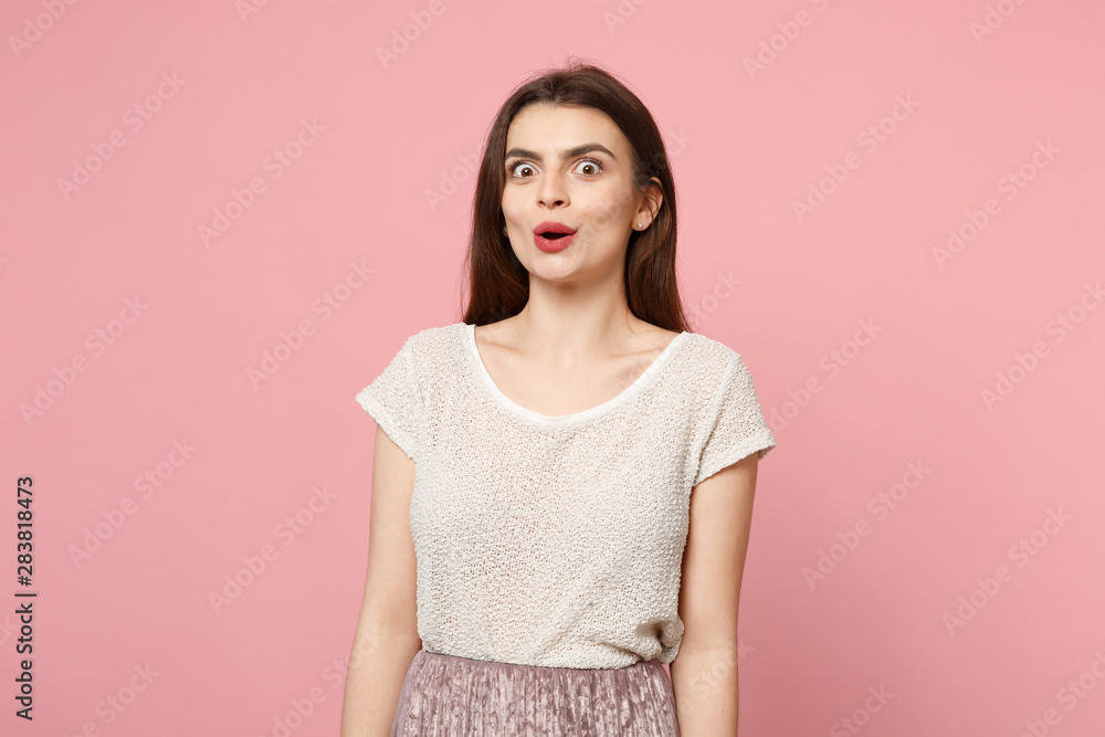 Amazed shocked young woman in casual light clothes posing isolated on pastel pink wall background, studio portrait. People sincere emotions lifestyle concept. Mock up copy space. Keeping mouth open. Amazed shocked young woman in casual light clothes posing isolated on pastel pink wall background, studio portrait. People sincere emotions lifestyle concept. Mock up copy space. Keeping mouth open.