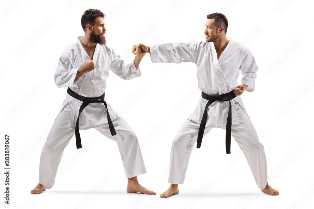 Two men in kimonos with black belt fighting Two men in kimonos with black belt fighting