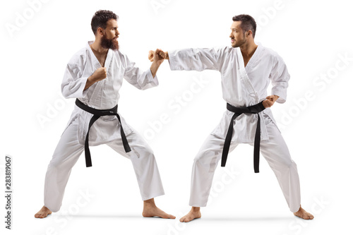 Two men in kimonos with black belt fighting