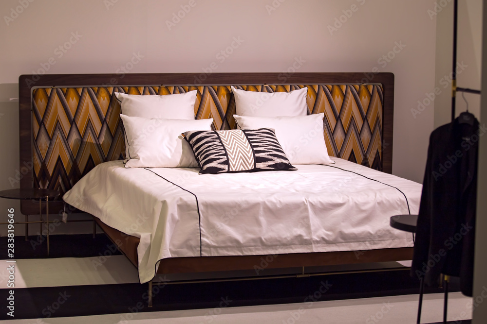 Obraz premium Modern stylish bedroom, double bed with headrest in the Art Nouveau style, retro, with a zigzag pattern, loft bedroom