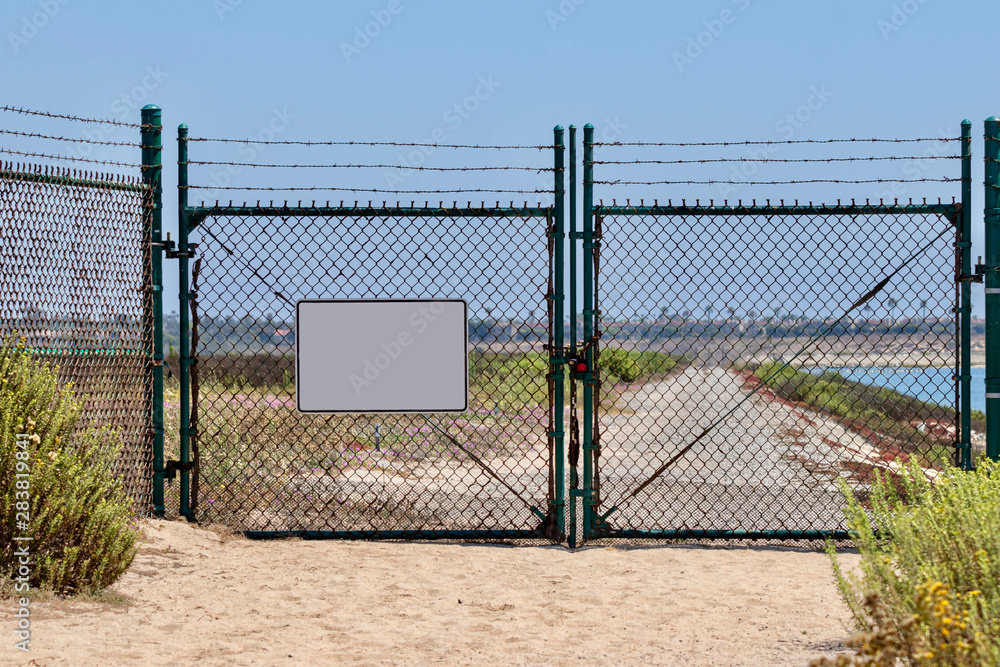 blank sign on chain link fence with gates 