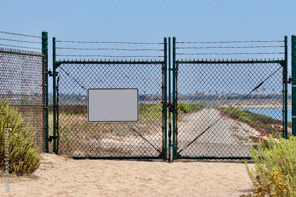 blank sign on chain link fence with gates blank sign on chain link fence with gates