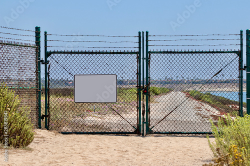 blank sign on chain link fence with gates  © K KStock