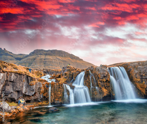 Famous travel location in Iceland. Kirkjufell Waterfalls at sunset, long exposure © jovannig