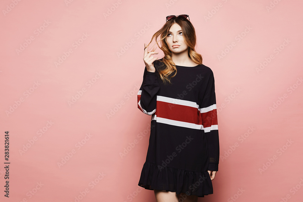 Young and beautiful model girl twirling hair and looking up Young and beautiful model girl twirling hair and looking up