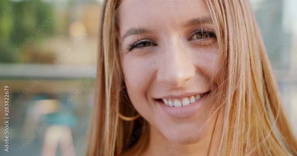 A young pretty lady smiling outdoors. Emotion A young pretty lady smiling outdoors. Emotion
