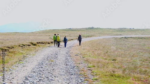 Scenic view of walking tourists on Bugeci Mountains of Brasov in the morning, Romania photo