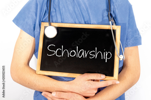 Doctor shows information on blackboard: scholarship.  Medical concept.