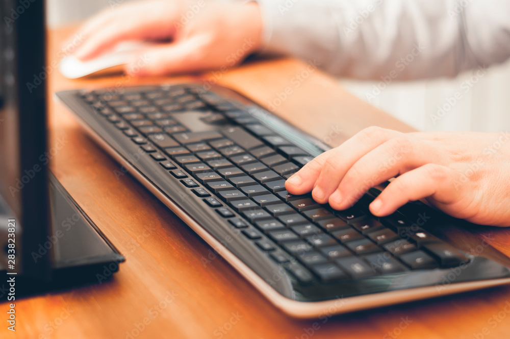 A man using computer, buy things online, searching informations or work at home. Soft focus image color graded A man using computer, buy things online, searching informations or work at home. Soft focus image color graded