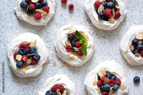 Classic dessert Pavlova with cream and berries. View from above.