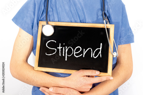 Doctor shows information on blackboard: stipend.  Medical concept.