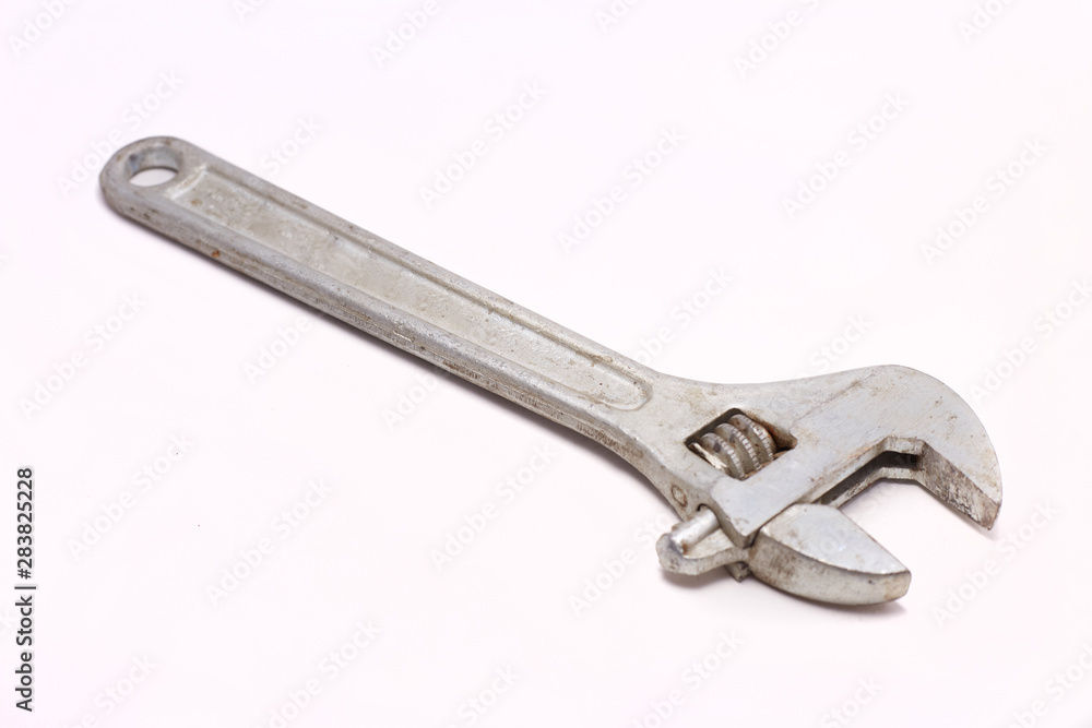 Adjustable wrench with red rubberized handle, isolated on white background Adjustable wrench with red rubberized handle, isolated on white background