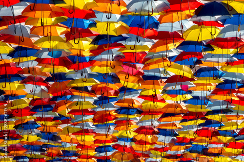 abstract colorful background of umbrellas in the sky