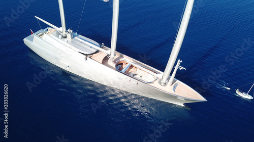 Aerial drone top view photo of sail boat docked in Mediterranean Aegean island of Santorini, Cyclades, Greece