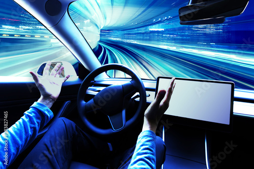 Person using a car in autopilot mode hands free photo