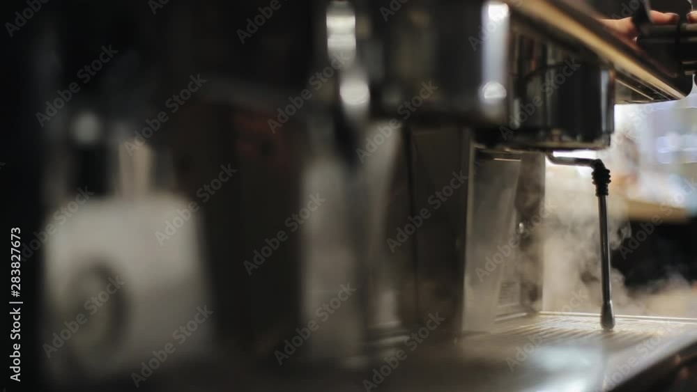 Steam coming out of a professional coffee machine. A close view Steam coming out of a professional coffee machine. A close view