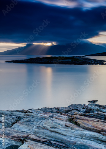 Fototapeta Naklejka Na Ścianę i Meble -  Sun bursting thru the dark sky over Landego in Bodo, Norway
