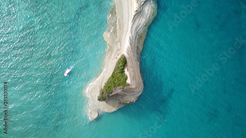 Aerial drone bird's eye view photo of iconic white rock volcanic tropical islet with emerald clear water sea