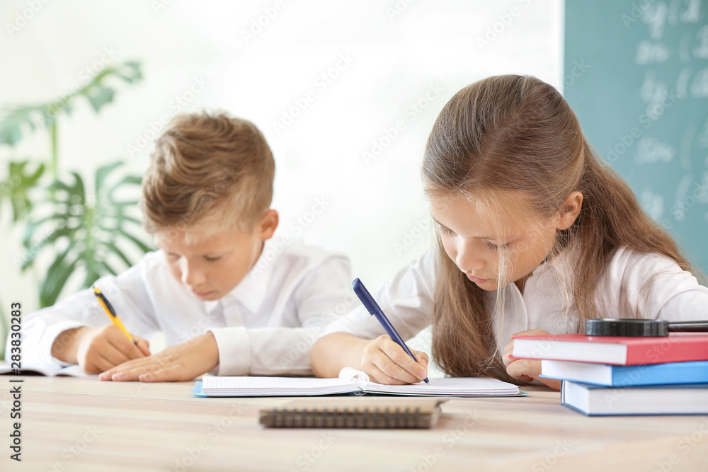 Little pupils doing lessons in classroom Little pupils doing lessons in classroom