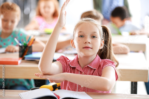 Cute little girl raising ha...