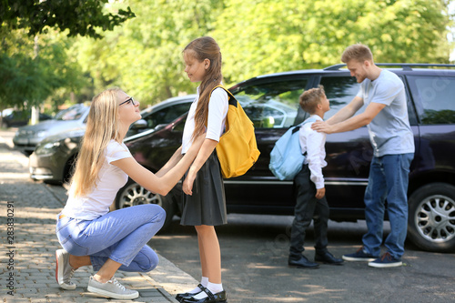 Parents saying goodbye to their children near school