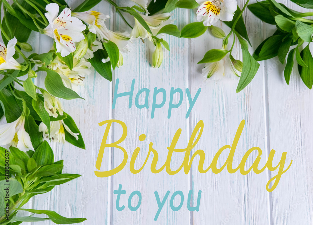 Obraz Happy Birthday to You. Birthday greeting card with flowers on a wooden background. Greeting card for girls, congratulations on mother's day. View from above