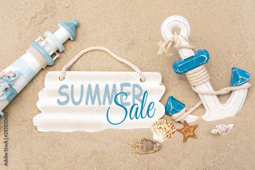 Banner summer sale. lighthouse, anchor with the inscription summer sale on a wooden background. Promotion, discount, sale