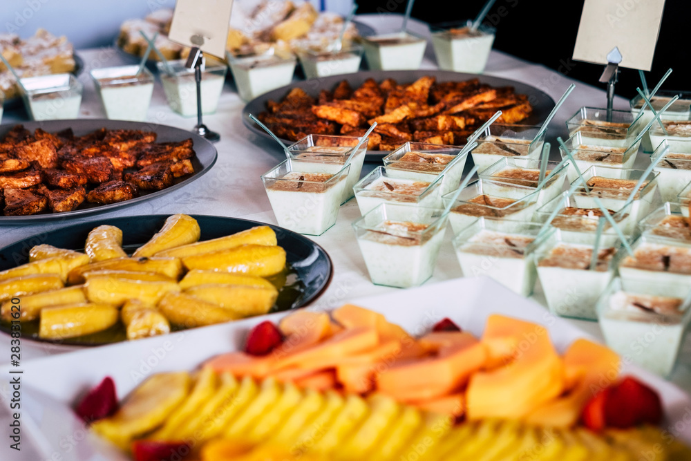 Catering and restaurant table with tasty cakes and fruit -coloured food and job concept