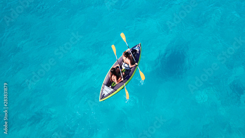 Aerial drone photo of 2 women canoeing in tropical Caribbean exotic destination with turquoise sea