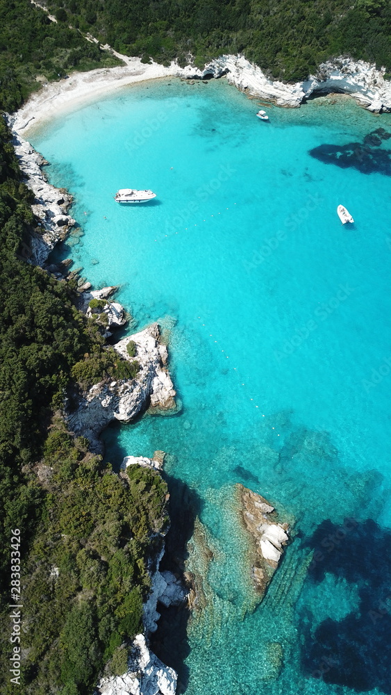 Aerial drone photo of beautiful exotic paradise turquoise sandy beach of Voutoumi with sail boats docked in island of Anti paxos, Ionian, Greece Aerial drone photo of beautiful exotic paradise turquoise sandy beach of Voutoumi with sail boats docked in island of Anti paxos, Ionian, Greece