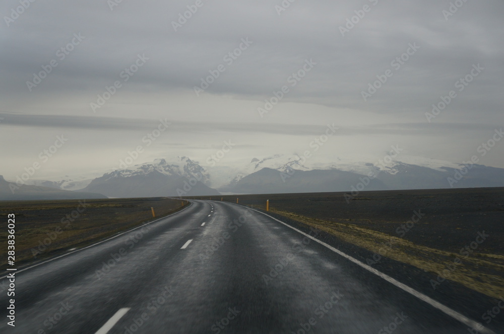 Driving on highway with glacier in the background Driving on highway with glacier in the background