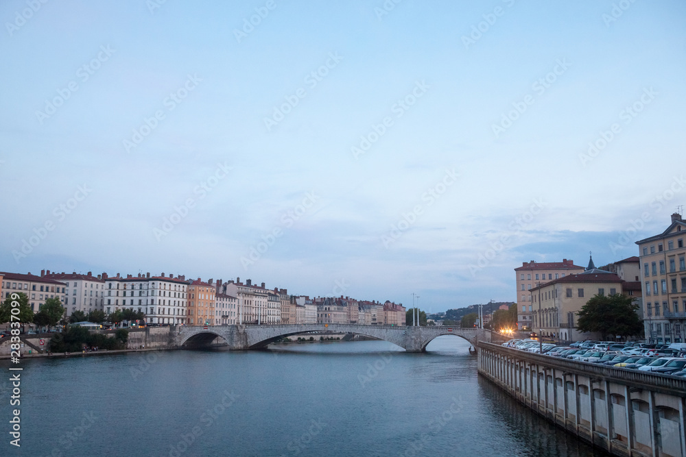 Panorama of Saone river and the Quais de Saone riverbank and riverside in the city center of Lyon, with a focus on the Pont Bonaparte bridge