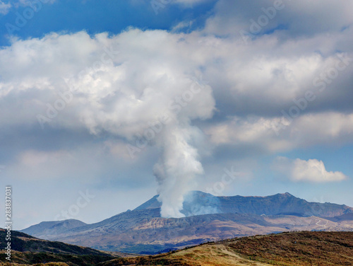 Japan's active volcano Mount Aso erupting with white smoke © lcc54613