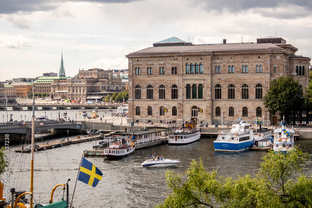 Obraz premium City view from Skeppsholmen island, Stockholm, Sweden. Features Nationalmuseum on Blasieholmen, Royal Swedish Opera on Norrmalm, and Skeppsholmsbron (bridge)