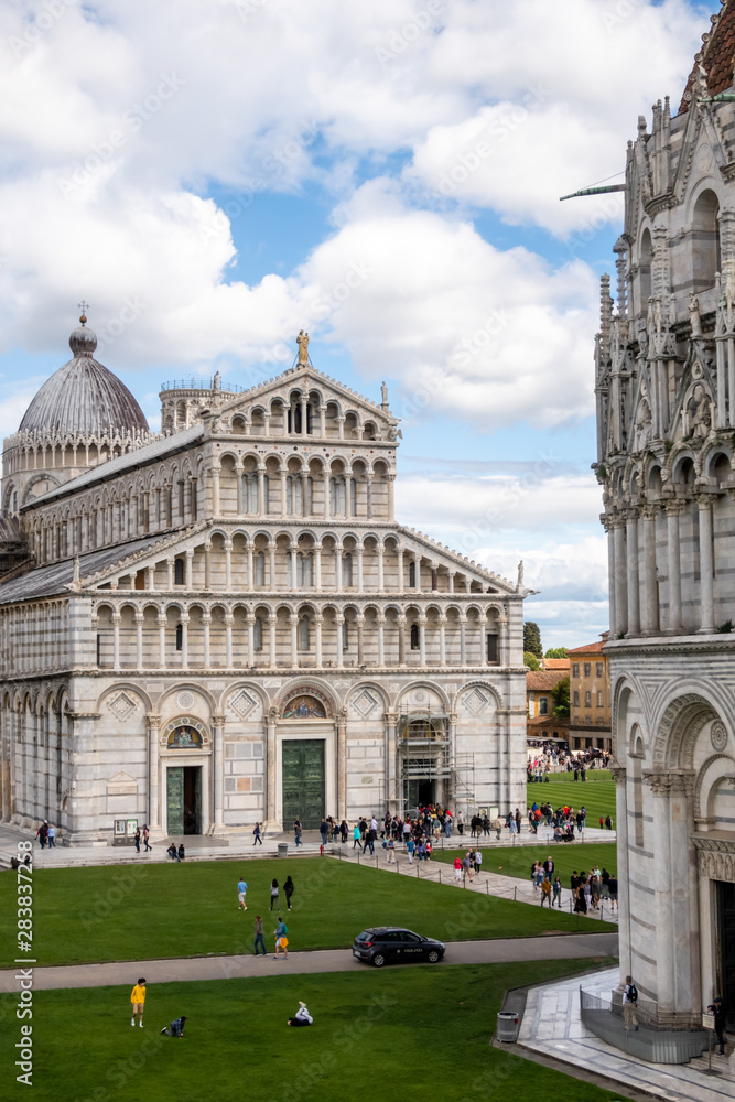The Duomo (Cathedral) of Pisa, and a fragment of the Baptistery. At the UNESCO World Heritage site Piazza del Duomo (Square of Miracles, Piazza dei Miracoli), Pisa, Tuscany, Italy