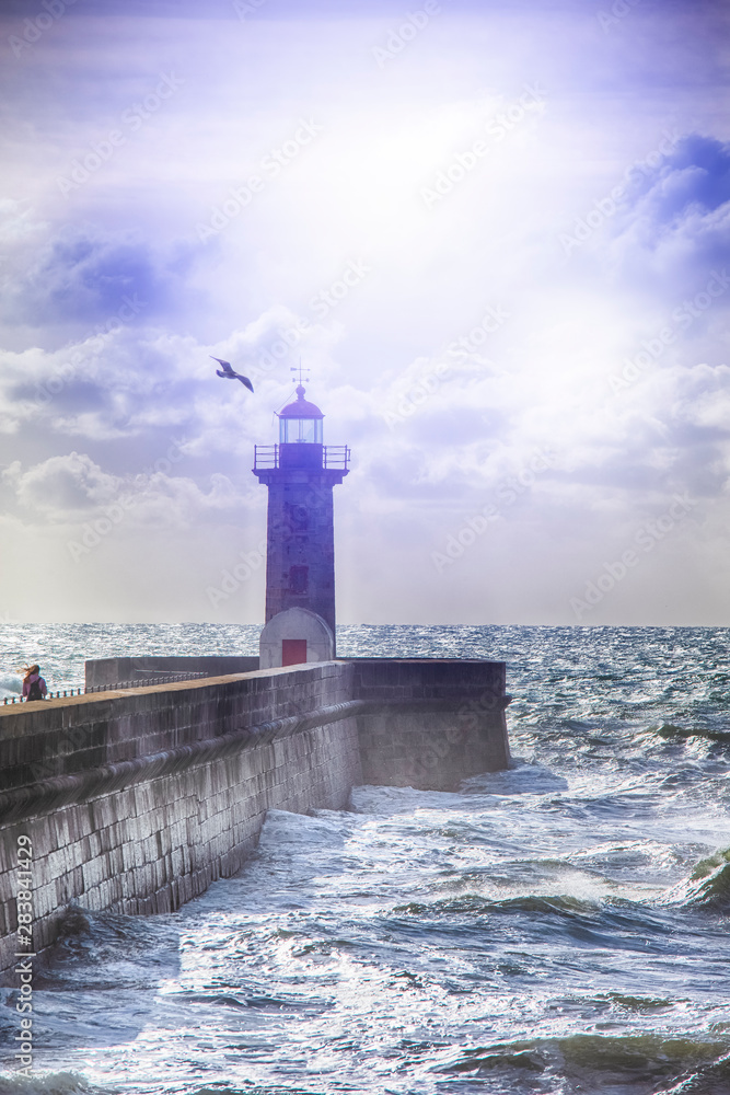 Lonely Lighthouse on the Pier in Porto City in Portugal Against Roaring Ocean.