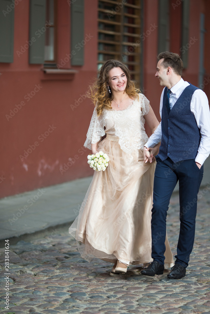 Portrait of Happy Caucasian Wedding Couple Having a Stroll Together.