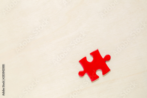 Fototapeta Naklejka Na Ścianę i Meble -  one red painted piece piece of jigsaw puzzle